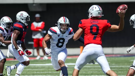 Anthony Pandy (8) rushes QB Gunner Cruz (9) during the spring game.