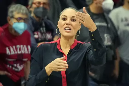 FILE - Arizona head coach Adia Barnes directs her team during the first half of an NCAA college basketball game against Washington State, on Jan. 7, 2022, in Tucson, Ariz. Barnes' feathery touch has reconstructed her alma mater from the rubble at the bottom of the Pac-12 to a national powerhouse. (AP Photo/Rick Scuteri, File)