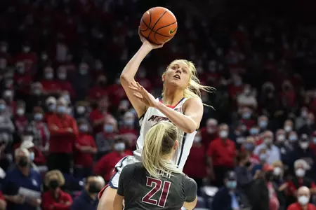 Arizona forward Cate Reese, top, shoots over Washington State guard Johanna Teder (21) during the first half of an NCAA college basketball game Friday, Jan. 7, 2022, in Tucson, Ariz. (AP Photo/Rick Scuteri)