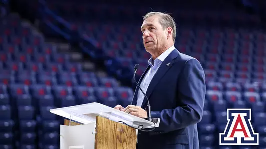 Dave Heeke in McKale Center speaking on a podium