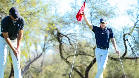 Christian Banke watches on as his teammate putts during a practice round at Tucson Country Club.