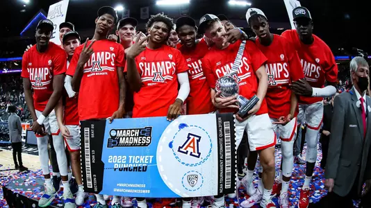 Arizona celebrates with the March Madness Punched Ticket after winning the Pac-12 Tournament