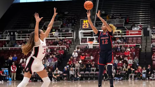 Arizona forward Esmery Martinez (12) takes a 3-point shot over Stanford guard Haley Jones (30) during the first half of an NCAA college basketball game Monday, Jan. 2, 2023, in Stanford, Calif. (AP Photo/Tony Avelar)