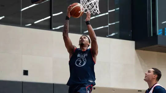 Cameron Holmes drives in for a layup at practice in Lithuania