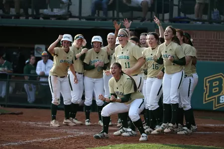 Baylor players await Clare Hosack's trip to the plate after her walk-off homer sunk UAB Friday night