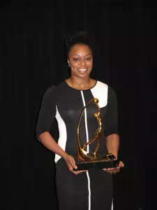 Odyssey Sims poses with the 2014 Wade Trophy.