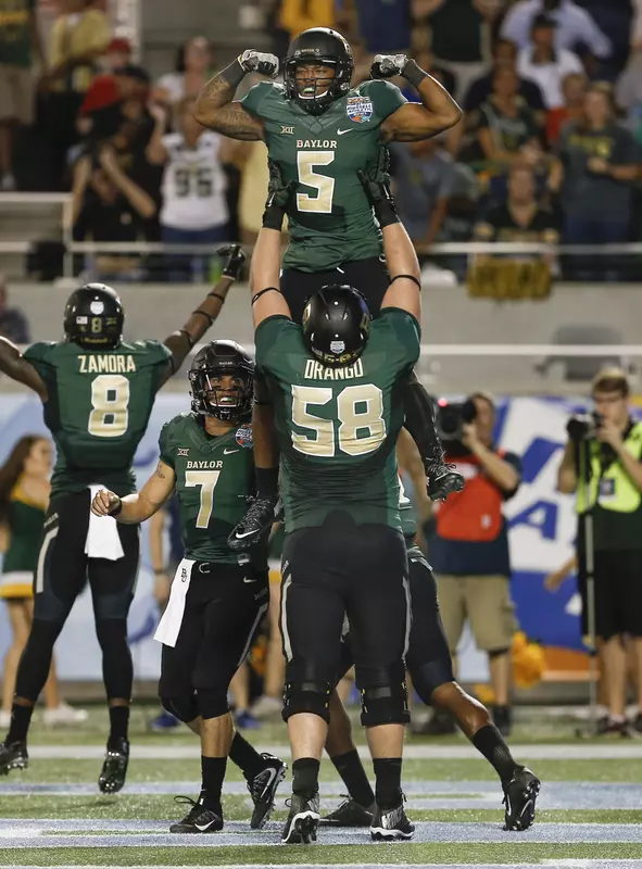 Johnny Jefferson is held up by offensive tackle Spencer Drango after a touchdown run.