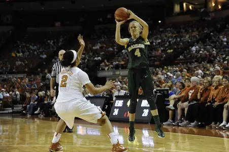 Kristy Wallace shoots the ball over Texas Longhorns guard Celina Rodrigo.