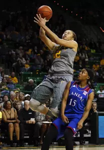 Feb 6, 2016; Waco, TX, USA; Baylor Bears guard Alexis Prince (12) shoots over Kansas Jayhawks guard Aisia Robertson (15). Credit: Ray Carlin-USA TODAY Sports