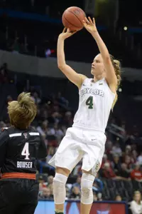 Kristy Wallace shoots the ball over Texas Tech Lady Raiders guard Ryann Bowser.