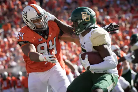 Bears wide receiver Denzel Mims (15) runs the ball against Oklahoma State Cowboys defensive end Jordan Brailford (94) Rob Ferguson-USA TODAY Sport