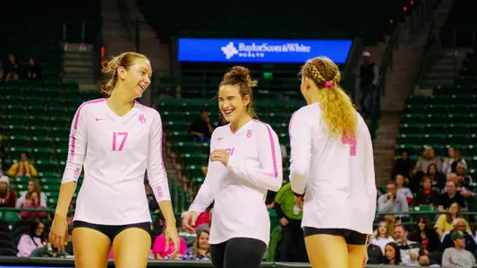 Elise and Kara McGhee celebrate a point with Allie Sczech.