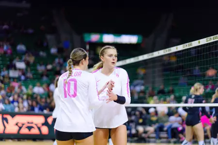 Allie Sczech and Sophia Keene strategize while subbing out.