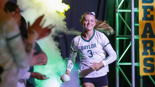 Averi Carlson runs out of the tunnel before the match.
