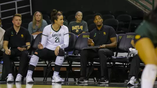 Elise McGhee and Joshua Walker talk strategy during the first set.