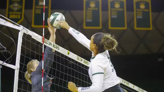 Lauren Harrison battles over the net during the first set.