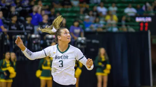 Averi Carlson looks back after saving a wild ball.