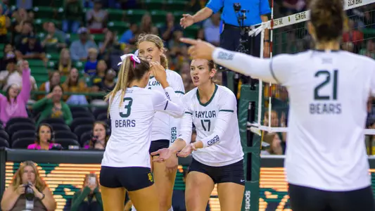 Kara McGhee celebrates a kill with Averi Carlson.