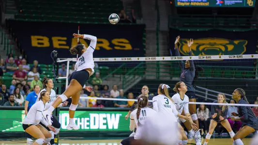 Lauren Harrison leaps for an attack in the third set.