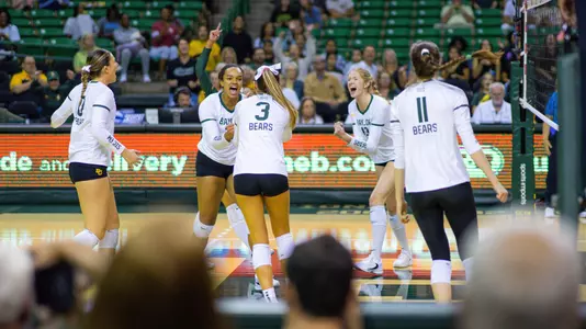 The Bears celebrate a kill by Mallory Talbert in the third set.
