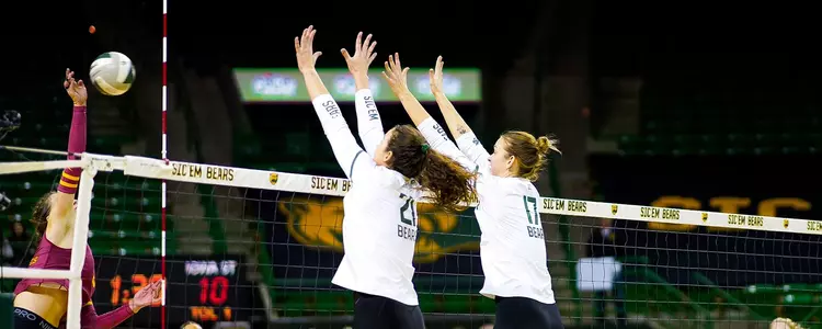Kara & Elise McGhee go up for a block against Iowa State