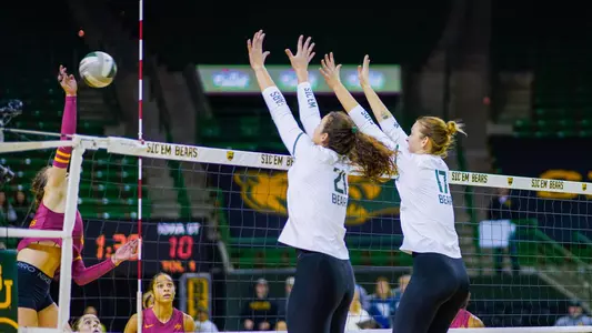Kara McGhee and Elise McGhee go up for a block against Iowa State