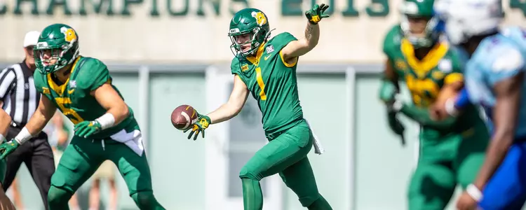 Issac Power punts against Kansas in 2022