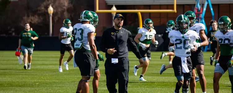 Coach Juice Johnson works with running backs