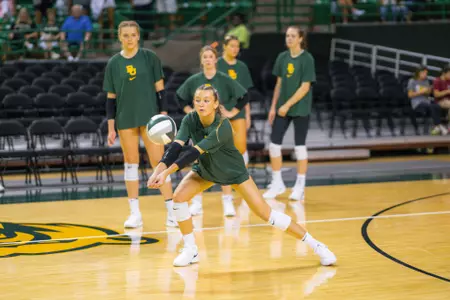 Averi Carlson bumps the ball during warmups.