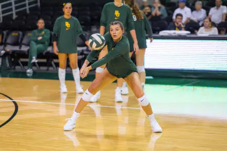 Alicia Andrew bumps the ball during warmups before hte match against Colorado State.