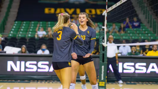 Alicia Andrew and Averi Carlson celebrate a point against Evansville.