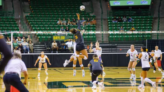 Lauren Harrison tips the ball against Evansville.