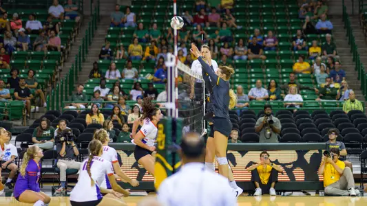 Kara McGhee and Allie Szech go up for a block against Evansville.