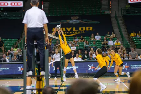 Averi Carlson battles over the net against ASU.