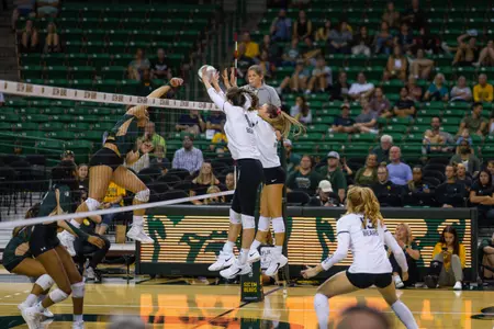 Mallory Talbert and Averi Carlson block an attack by Colorado State.