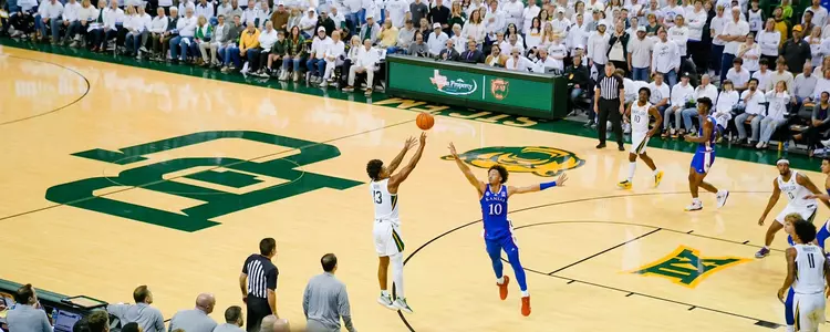Langston Love shoots a 3-pointer against Kansas