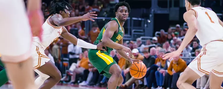 Adam Flagler dribbles at Texas 2023