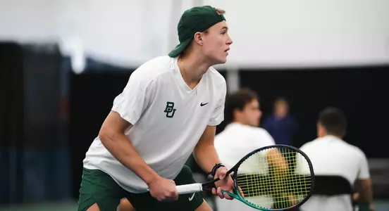 Luc Koenig awaiting serve at ITA Indoor Nationals vs. TCU