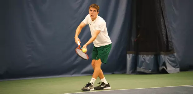 Ethan Muza serving at the ITA Indoor Team Championships