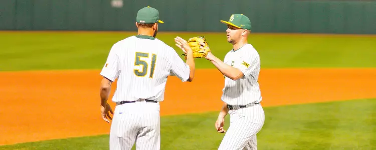 Adam Muirhead high-fives Cole Stasio after pitching against HCU 2023