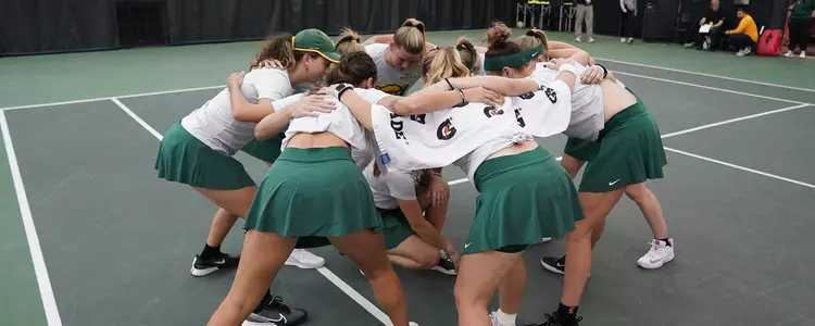 Tennis Team Huddle inside Hawkins Indoor