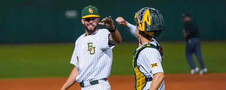 Cole Stasio and Harrison Caley high five vs DBU in 2023