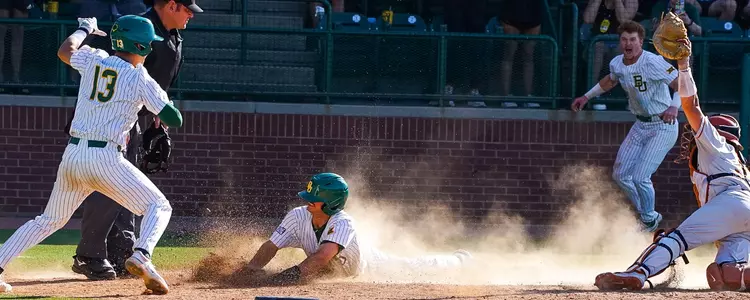 Caleb Bergman slides in safely against Texas in 2023