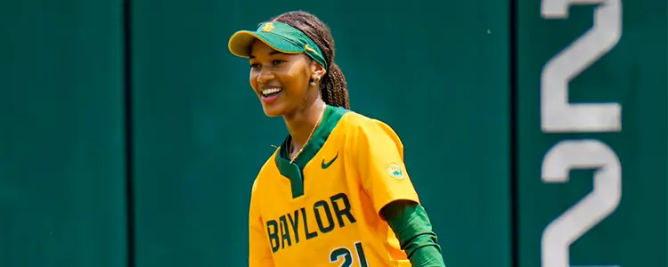 McKenzie Wilson smiles after making a play in the outfield
