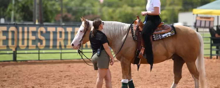 Casie Maxwell talks to a student-athlete in the Western pen