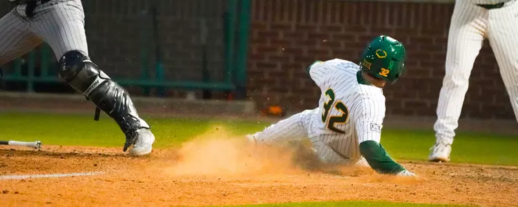 Caleb Bergman slides into home against Abilene Christian
