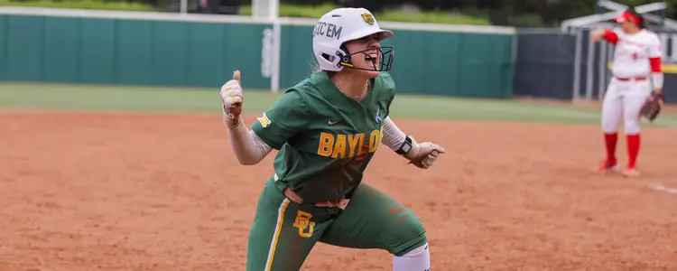Emily Hott celebrating after a triple against Houston