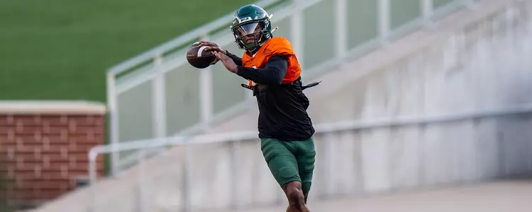 Dequan Finn throwing a pass during a fall scrimmage 2024