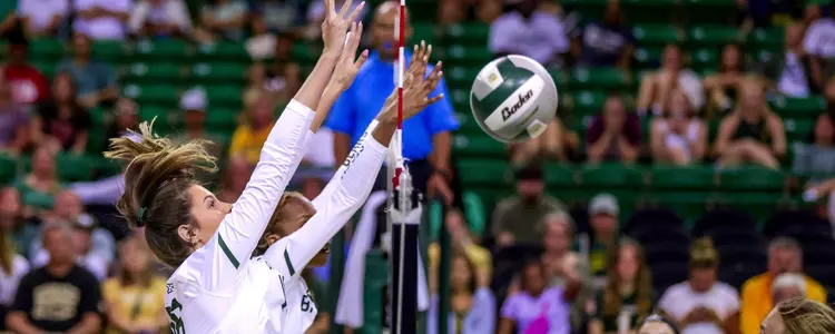 Grace Carroll blocks against the Aggies