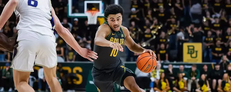 Isaac Williams driving to the basketball vs. Washington